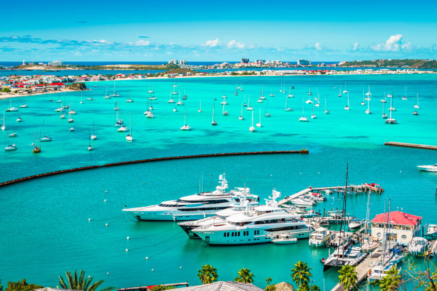 Luxury yachts and boats docked in the picturesque marina of Marigot, St Martin, surrounded by tropical scenery
