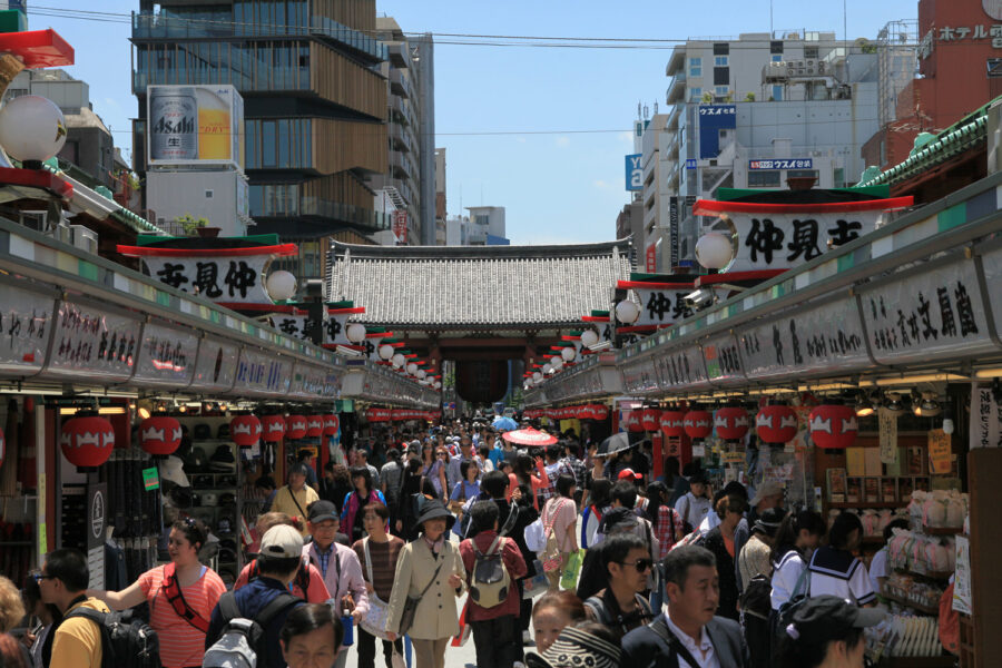 Nakamise Shopping Street Tokyo market with red lanterns leading to Senso-ji temple gate.