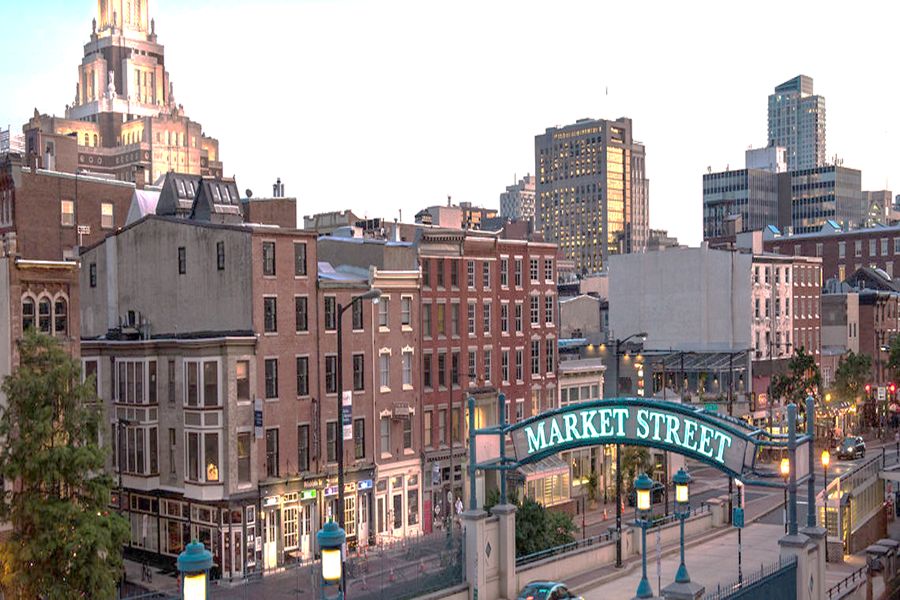 Market Street Philadelphia: vibrant urban mix of historic and modern architecture with lush greenery.