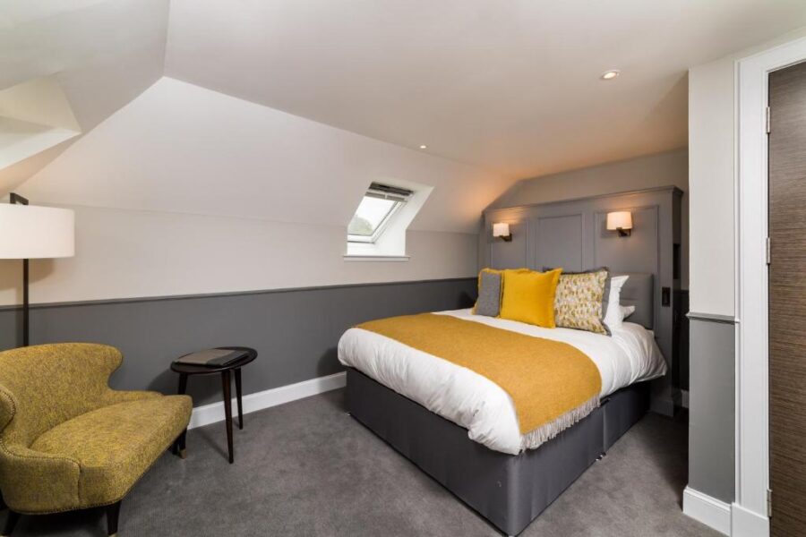 Cozy bedroom featuring a yellow and white bed, located at Marmalade accommodation, Portree, UK.
