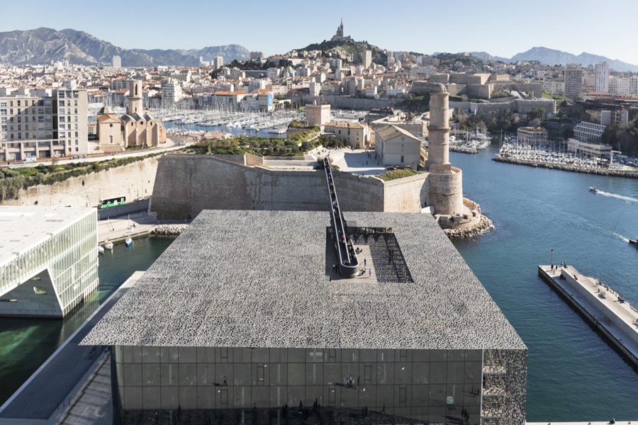 Aerial view of Marseille, showcasing MUCEM, Notre-Dame de la Garde, and vibrant harbor.