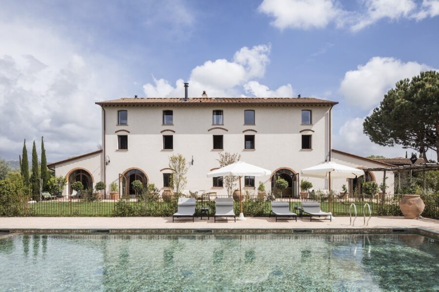 Elegant Italian villa with pool, lush garden, and traditional architecture.
