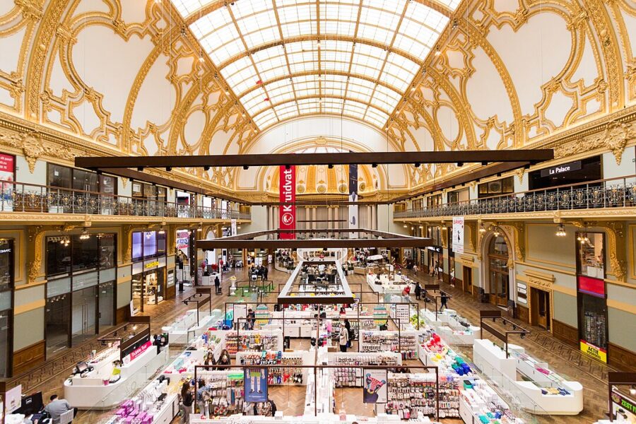 The grand structure on Meir Shopping Street, Antwerp, showcases a ceiling richly decorated in gold.

