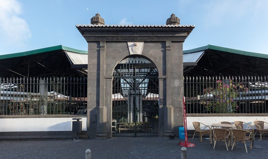 The Mercado da Graça in Portugal features a prominent building with a gate and a clock.