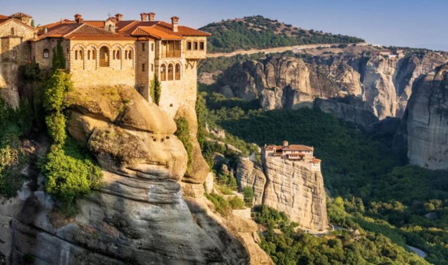 Meteora monasteries perched on cliffs in Greece at sunset, blending nature and architecture.
