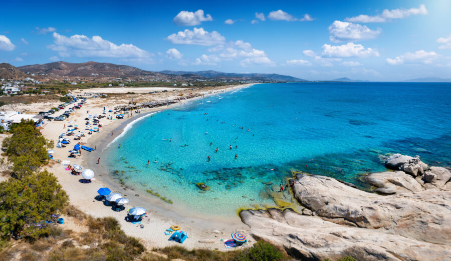 Aerial view of Mikri Vigla beach, showcasing turquoise waters and sandy shores on Naxos island, Cyclades, Greece.