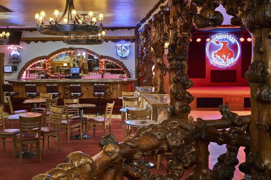 Interior view of the Million Dollar Cowboy Bar in Jackson, WY, featuring rustic decor and cowboy-themed furnishings