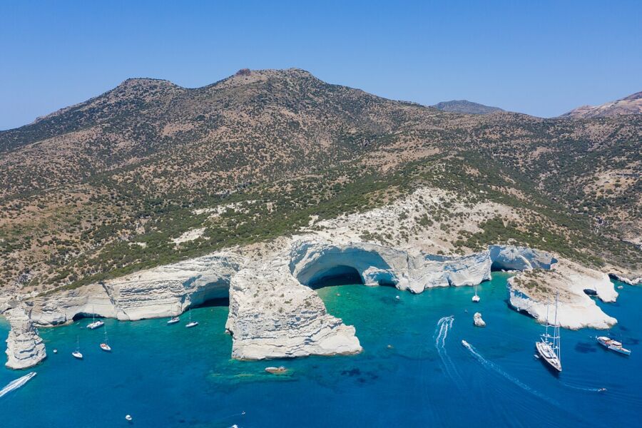 Blue waters of Kleftiko, Milos Island, framed by striking white cliffs under a clear sky.
