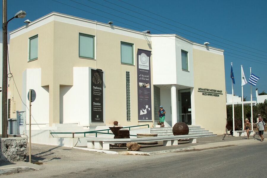 Exterior view of the Milos Mining Museum in Greece, showcasing its distinctive white roof.