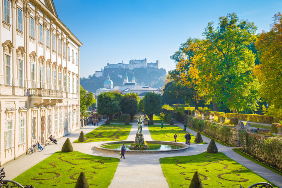Mirabell Gardens and Palace in Salzburg, Austria, with Hohensalzburg Fortress visible in the background.