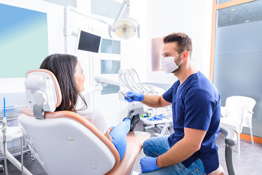 Modern dental office with dentist consulting a female patient.
