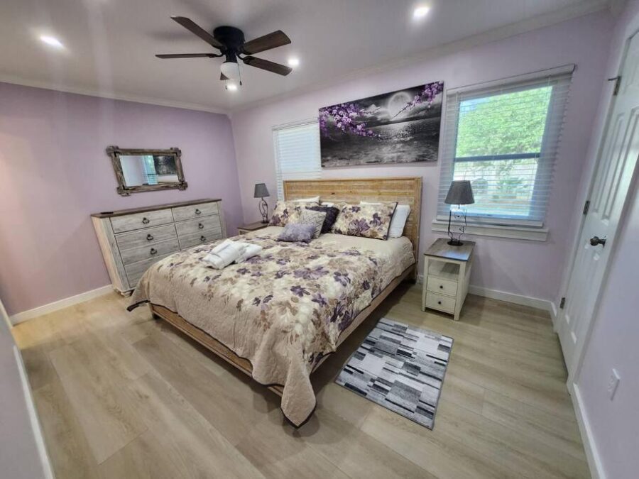 Modern bedroom featuring purple walls and a comfortable bed, located in a pet-friendly villa in Hilton Head Island.
