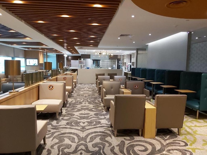 Modern lounge with neutral tones, cozy seating, and contemporary design elements.