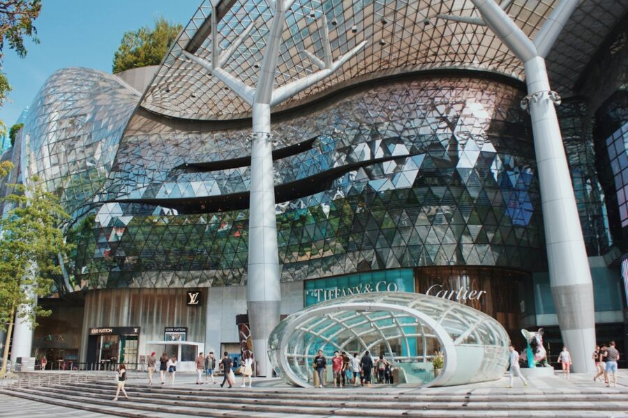 Orchard Road shopping district with modern architecture featuring glass and metal, including high-end brands.