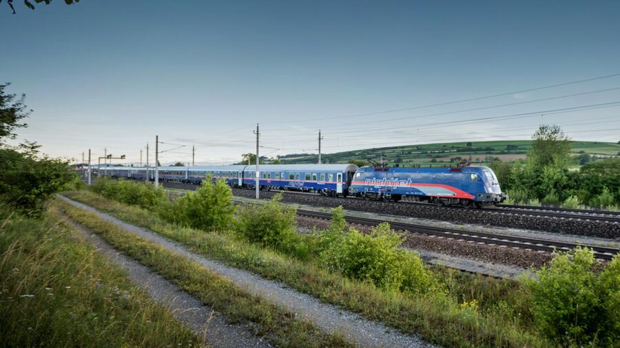 Modern sleek train mightride traverses scenic countryside, blending nature and technology.