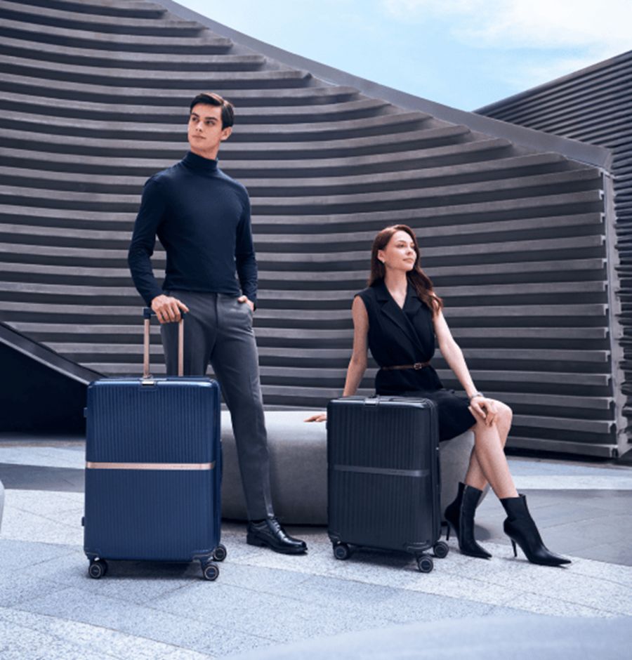 Modern travel fashion scene with stylish models and designer luggage.