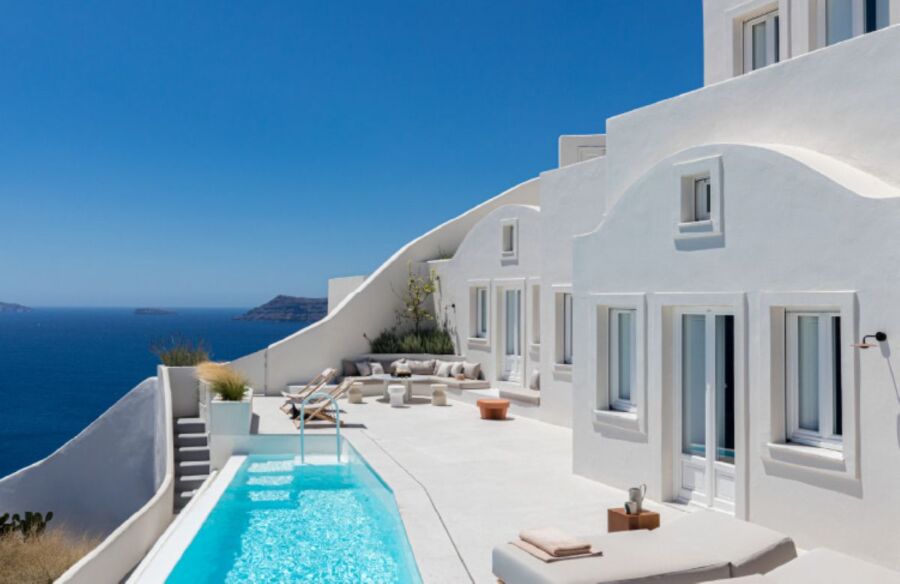 Luxurious Mediterranean villa with pool, overlooking the Aegean Sea, featuring whitewashed architecture.