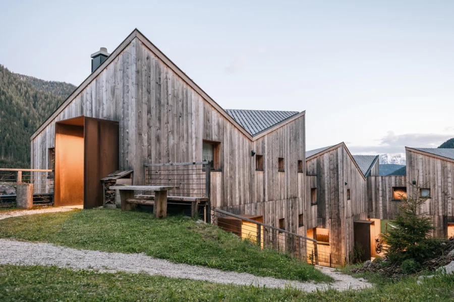 Contemporary eco-friendly mountain lodgings with wooden architecture and stunning alpine views.