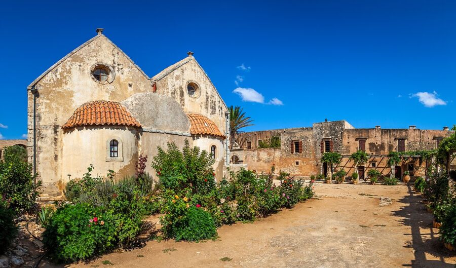Panagia Ekatontapiliani, featuring a prominent clock tower and a wall-mounted clock.