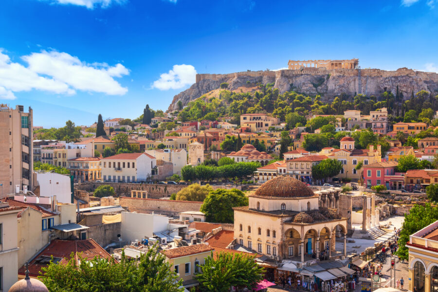 Sunset over Athens skyline featuring Monastiraki Square and Acropolis Hill, highlighting the city's historic architecture