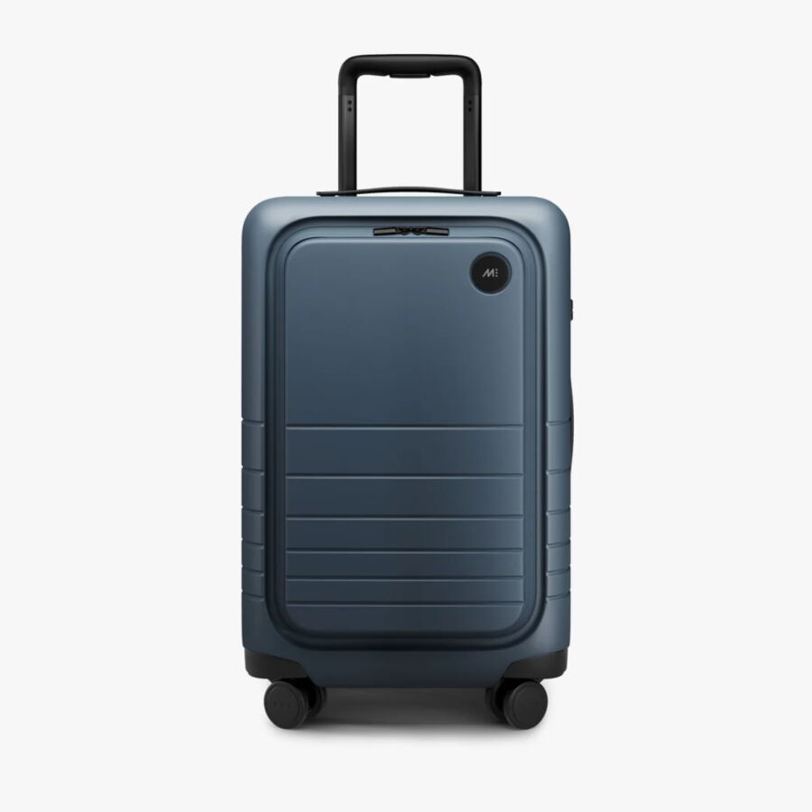 Blue Monos Carry-On Pro suitcase with wheels, displayed on a clean white background.