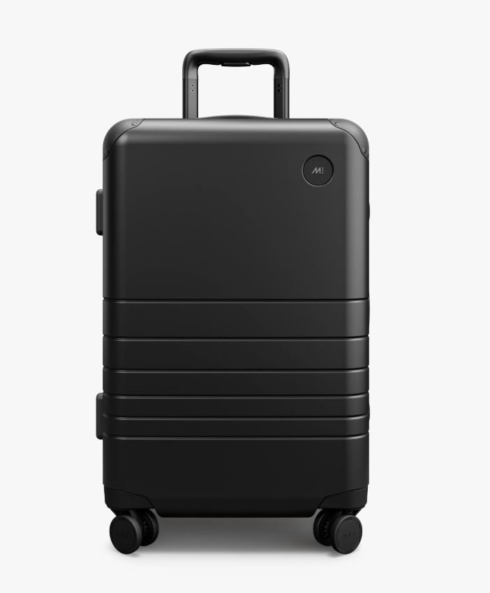 Black Monos Hybrid Carry-On Plus suitcase with wheels on a white background.