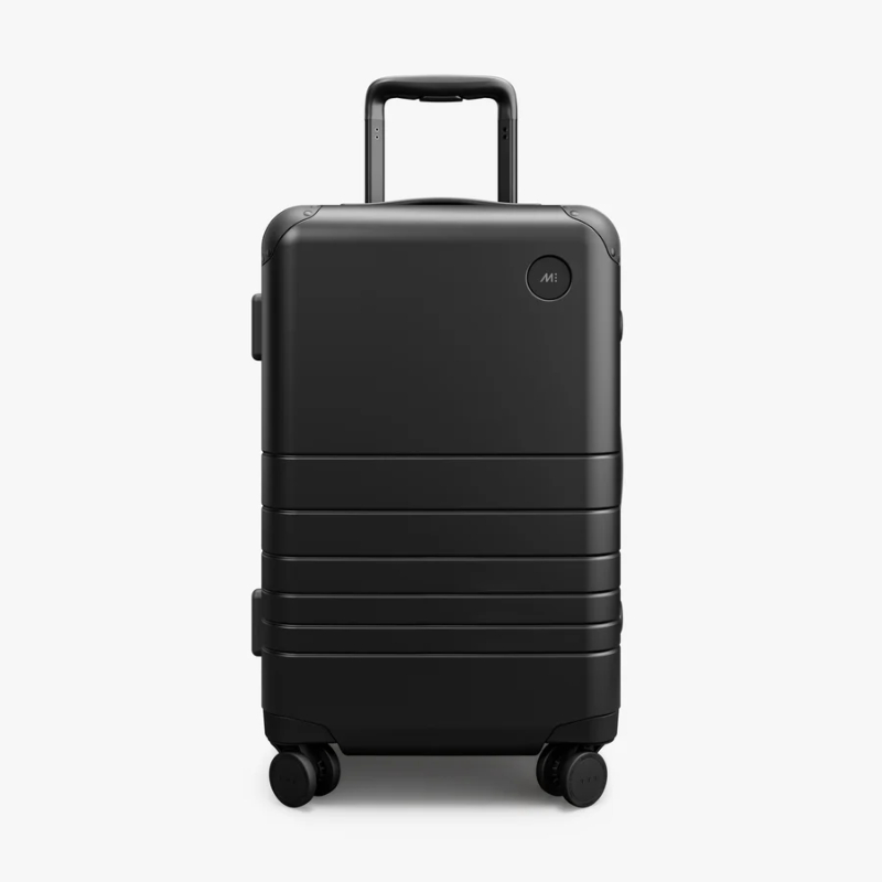 Monos Hybrid Carry-On suitcase, black with wheels, displayed against a white background.