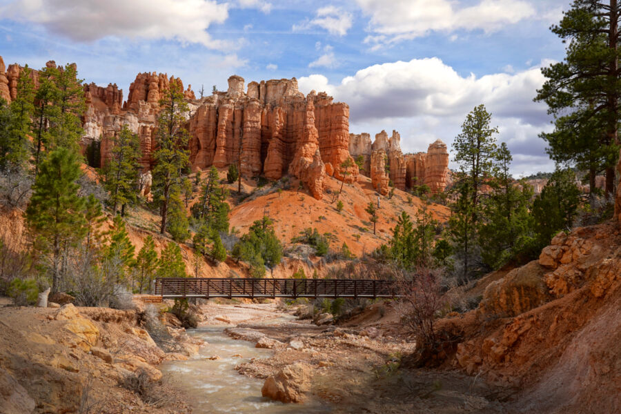 Sunset over Bryce Canyon National Park, showcasing vibrant orange and purple hues illuminating the unique rock formations