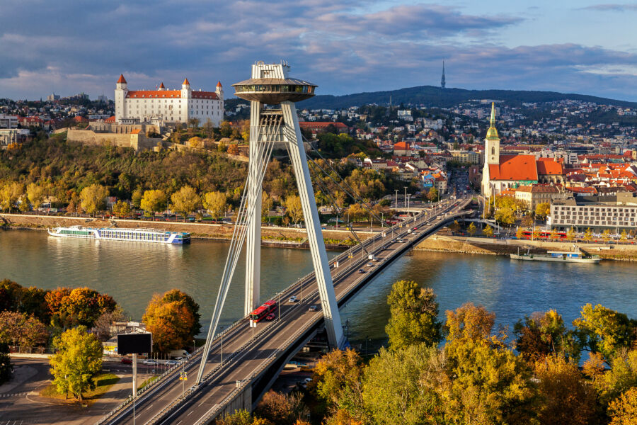 View of SNP Bridge in Bratislava, Slovakia, featuring vehicles traveling across the iconic structure