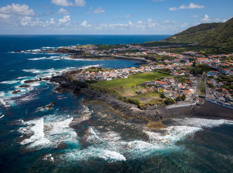 Beautiful coastline of Mosteiros, São Miguel Island, showcasing rugged cliffs and serene ocean waves on a sunny day.