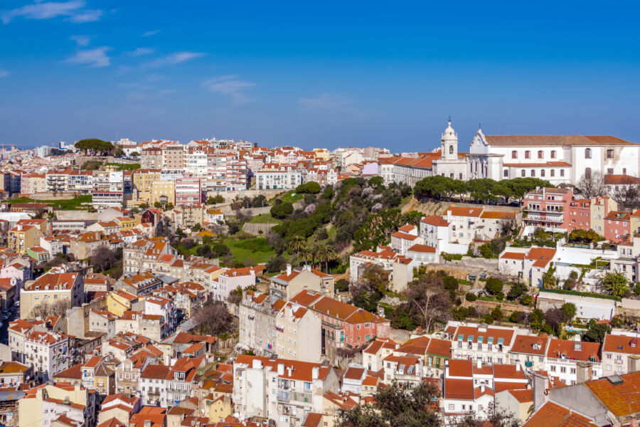 Scenic view from Castelo de Sao Jorge showcasing Mouraria and Graca districts, featuring Graca Church in Lisbon, Portugal