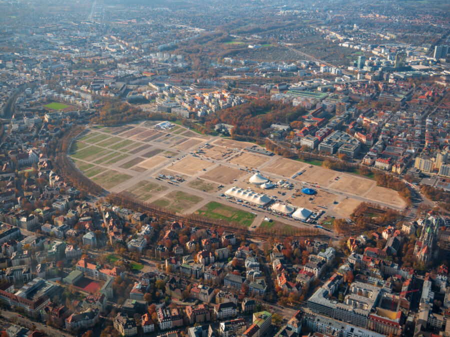 Theresienwiese in Munich, bustling with visitors enjoying food, rides, and festive decorations during Oktoberfest.