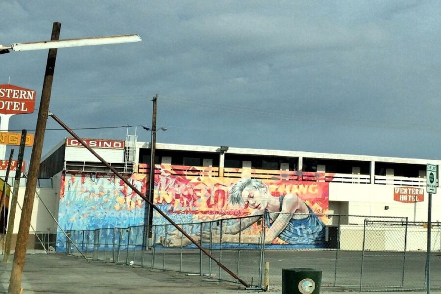 Mural on North Las Vegas in urban setting with casino sign and aging architecture.