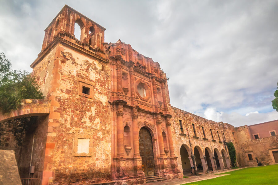 Exterior view of the Rafael Coronel Museum in Zacatecas, featuring unique architecture and surrounded by historic landmarks