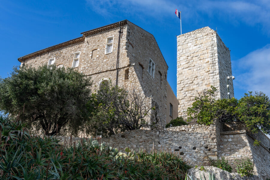 Exterior view of the Museum of Picasso in Antibes, France, showcasing its modern architecture and surrounding gardens.