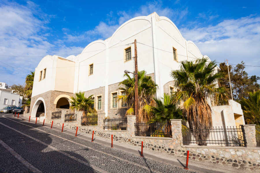 Exterior view of the Museum of Prehistoric Thera in Santorini, showcasing its modern architecture and surrounding landscape