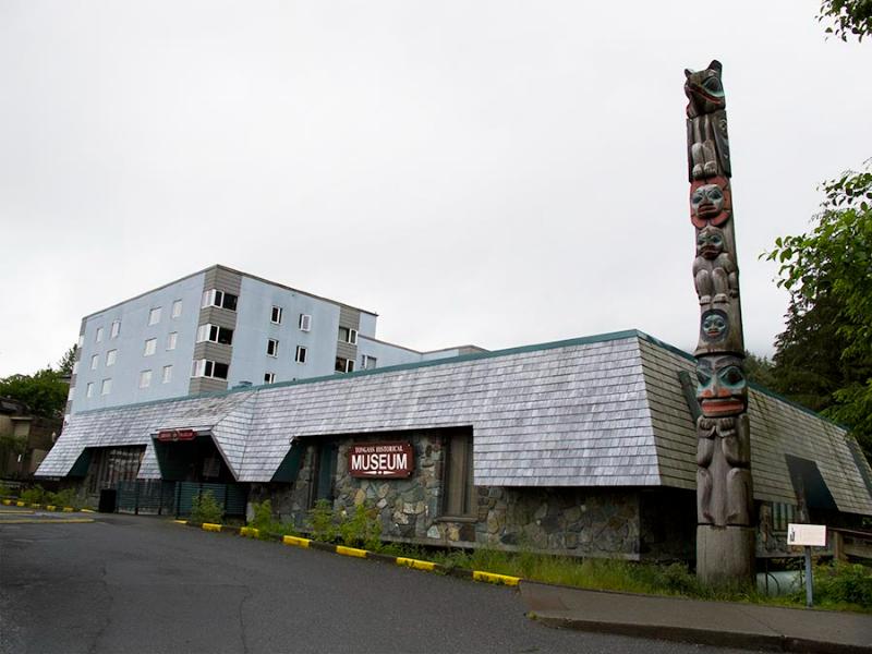 Tongass Historical Museum exterior with carved totem pole in front.