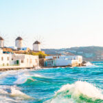 Sunrise view of iconic Greek windmills on Mykonos island, highlighting the picturesque landscape of the Cyclades