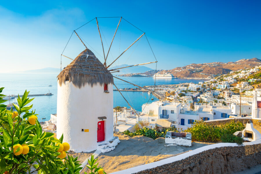 Panoramic view of Mykonos town, showcasing white buildings and blue sea in the Cyclades islands, Greece 