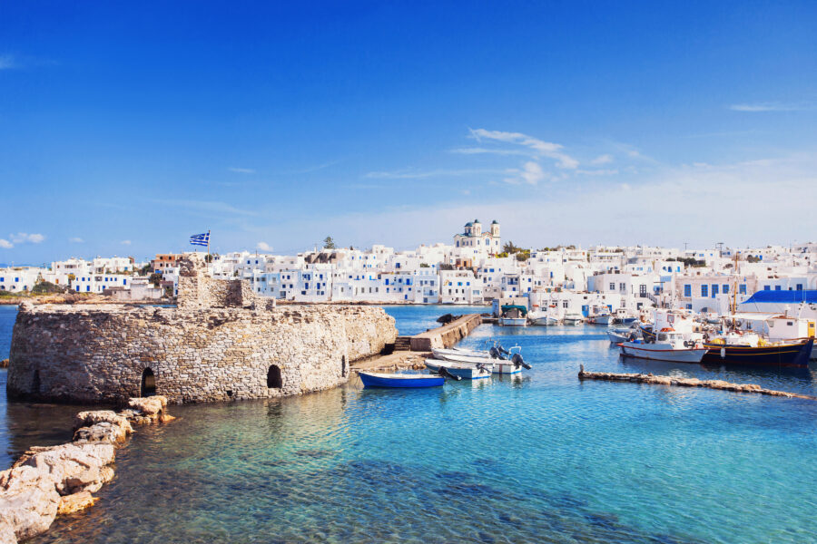 Scenic view of Naousa village on Paros island, showcasing traditional Cycladic architecture and vibrant blue waters