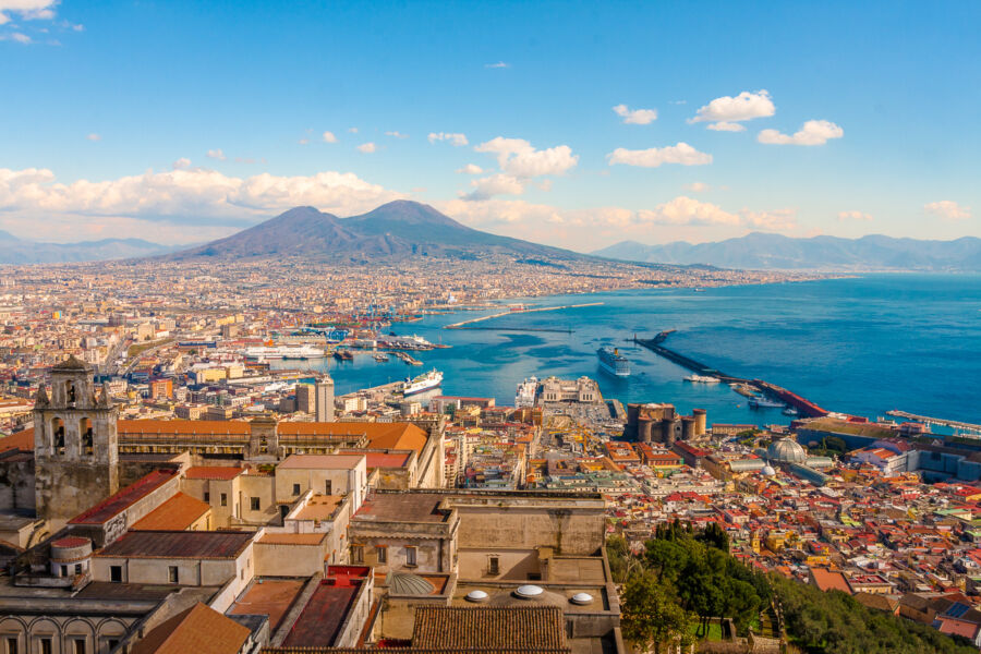 Panoramic view of Naples cityscape featuring the iconic Mount Vesuvius in the background