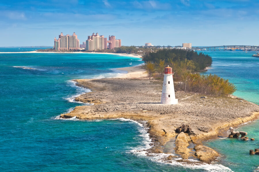Panoramic view of Nassau, Bahamas, showcasing vibrant buildings, turquoise waters, and lush greenery under a clear sky