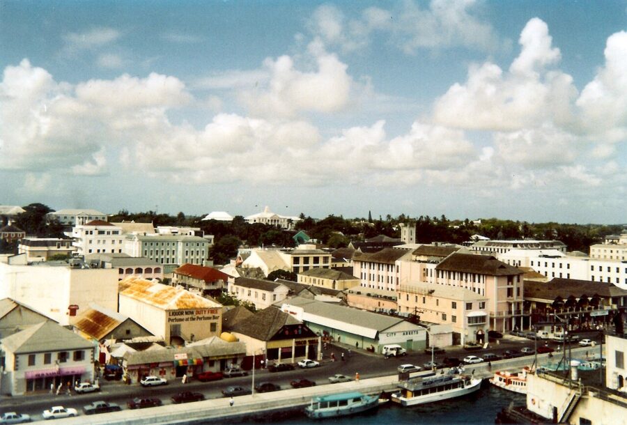 Nassau, Bahamas skyline of low buildings under a clear sky, the New Providence area jitneys cover by day.