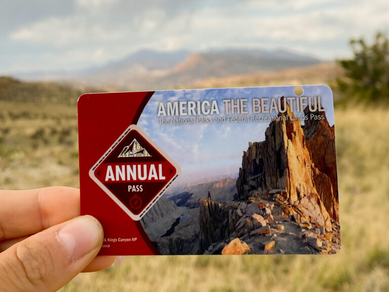 Annual America the Beautiful pass for national parks, featuring rugged landscape and adventure.