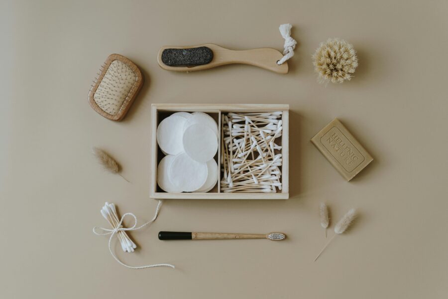 Eco-friendly grooming items arranged for minimalist self-care routine on a neutral background.