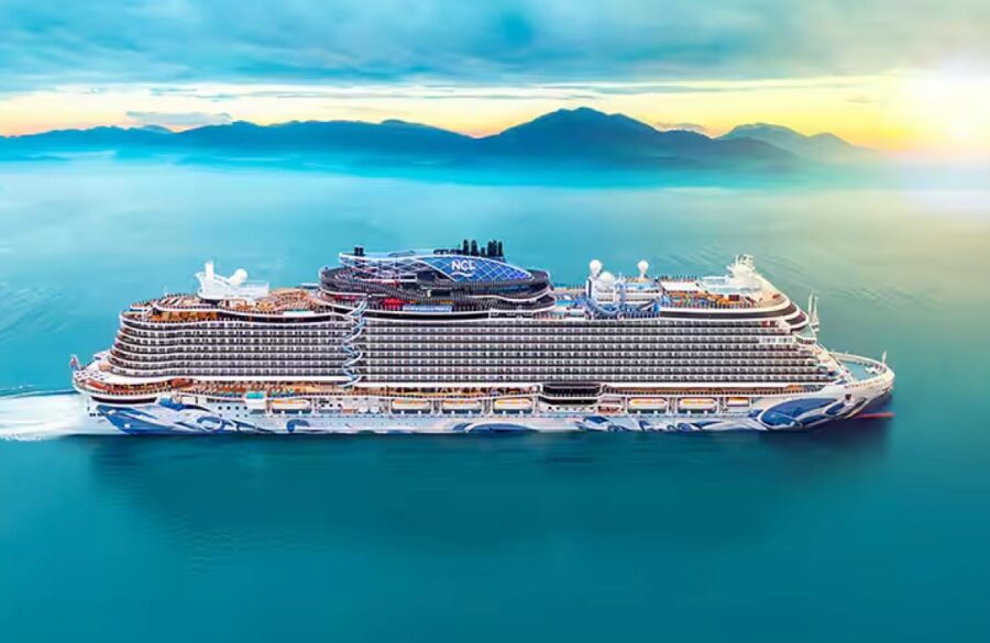 Luxurious Norwegian Cruise Line ship sails serene turquoise waters at dawn.