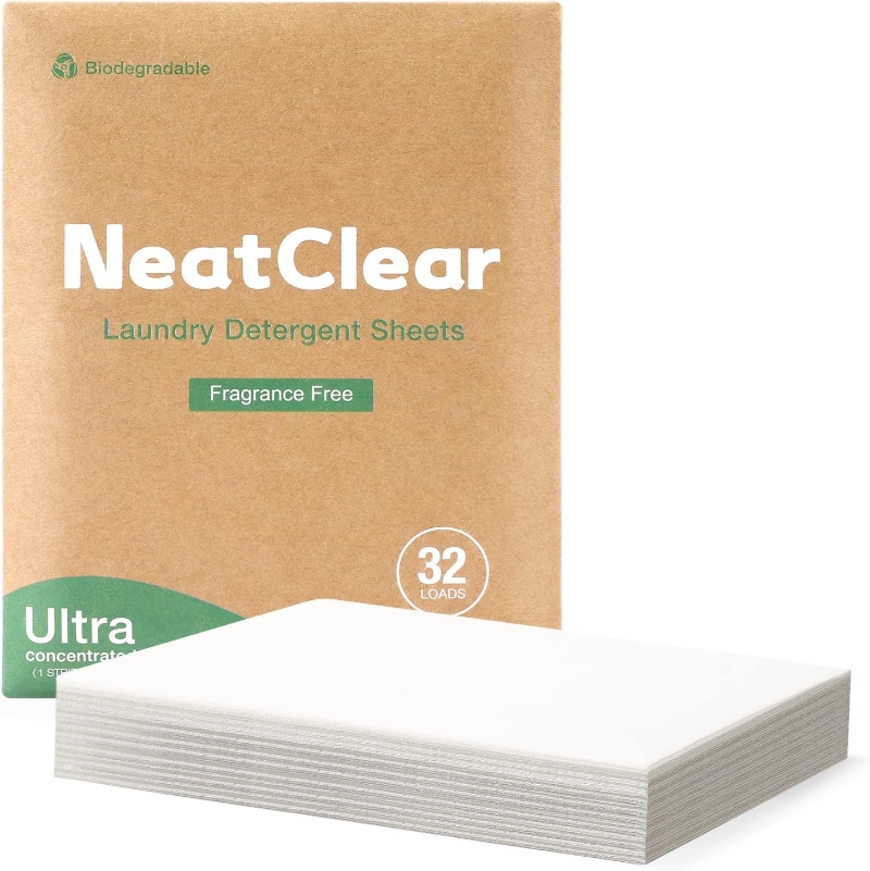 Brown packaging box of "NeatClear" laundry detergent sheets with "Fragrance Free" label. Stack of white sheets in front. Eco-friendly, 32 loads.