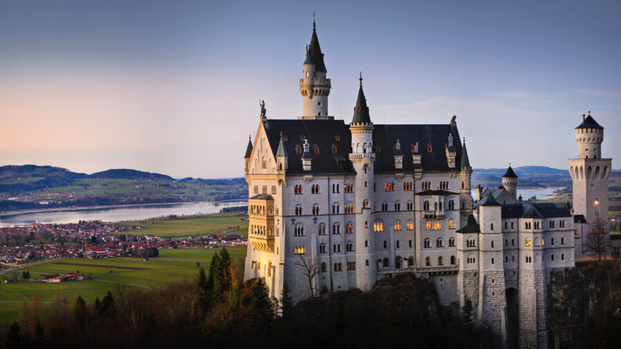 Autumn view of Neuschwanstein Castle surrounded by colorful fall foliage in Bavaria, Germany