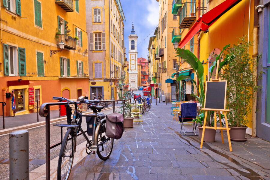 Colorful street architecture and a church in Nice, France, showcasing vibrant buildings and historic design elements