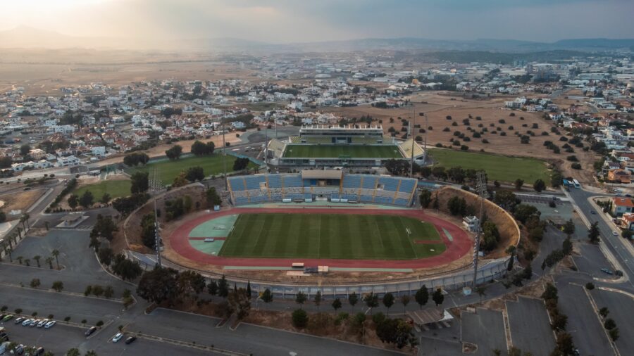 Aerial view of a football stadium in Nicosia, Cyprus, showcasing the field and surrounding stands.